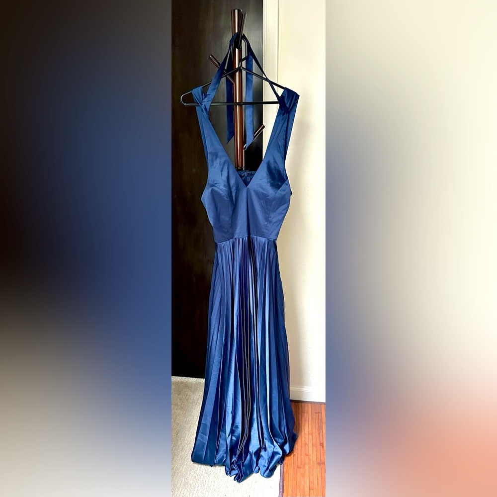 Floor length, blue dress, straps and tie around neck, low back zipper closure.